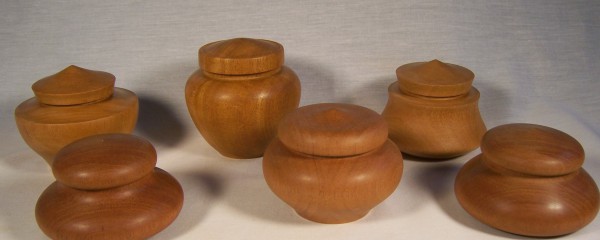 A collection of lidded boxes in light mahogany